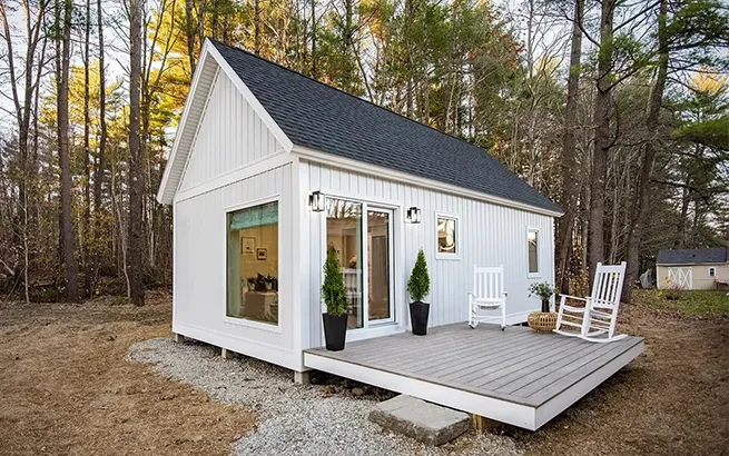 Custom-built detached Accessory Dwelling Unit (ADU) in a Boston Metrowest backyard, featuring modern siding and large windows.