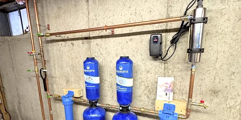 Modern PEX plumbing manifold installation and water filtration system by LK Home Renovations in Massachusetts.