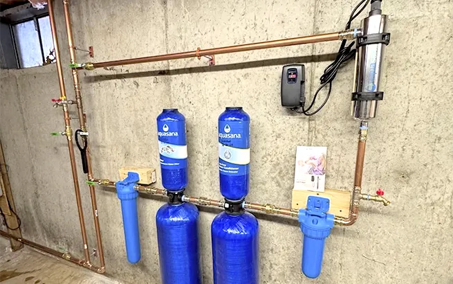 Professional plumbing installation of a whole-house water filtration and UV conditioning system by in-house experts in Massachusetts.